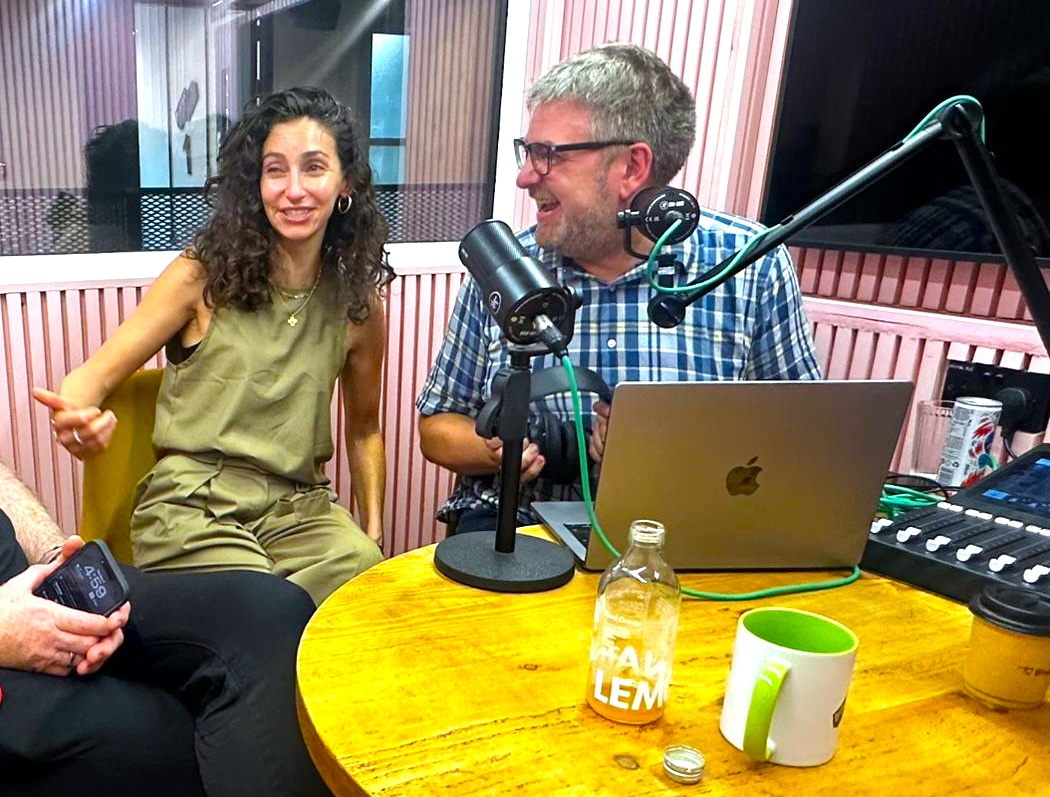 Carl Partridge and Emily Bendell laughing during a recording in the studio